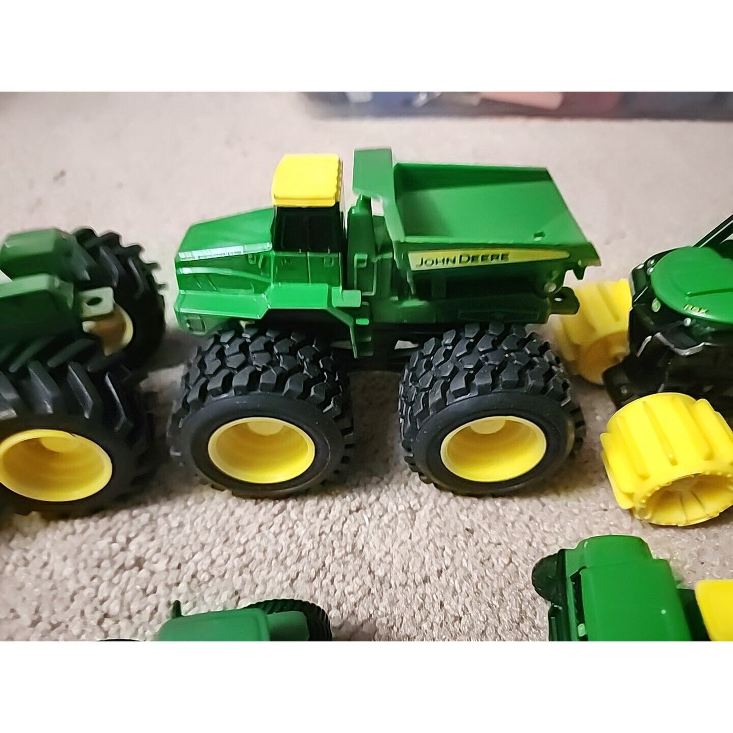 Lot of John Deere seven Monster Tire Vehicles