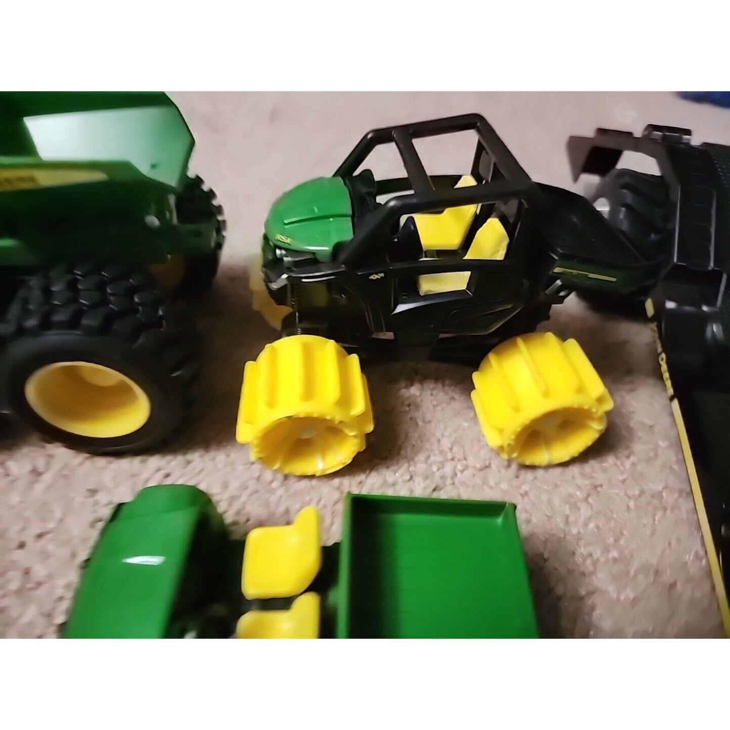 Lot of John Deere seven Monster Tire Vehicles